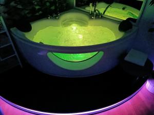 a bath tub with a green smiley face in it at Hotel Youri Il Magnifico in Genoa