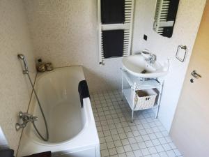 a bathroom with a sink and a tub and a toilet at VILLA AS Campo Marzio in Lenno