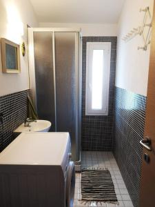 a bathroom with a shower and a sink at VILLA AS Campo Marzio in Lenno