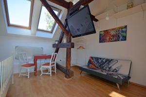 a living room with a tv and a table with chairs at CASA ADO in Oradea
