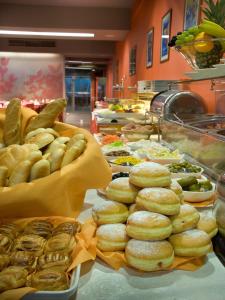 a buffet line with donuts and other food on display at EA Hotel Julis in Prague
