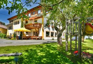 a building with a tree in the yard at Gasthof Neuwirt in Schöder