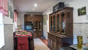 a kitchen with wooden cabinets and a table in a room at Apartman Sara - Delnice in Delnice