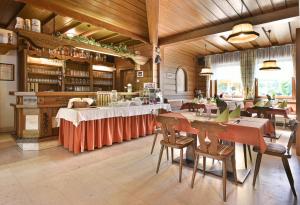 a restaurant with tables and chairs in a room at Gasthof Neuwirt in Schöder