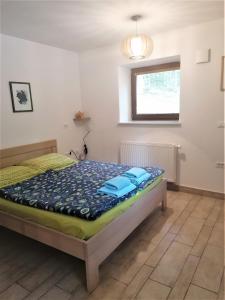 a bedroom with a bed with blue towels on it at Apartments Villa Vesna Pokljuka in Goreljek