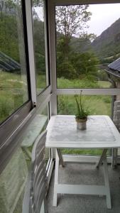 a table and a chair in front of a window at BOYRIE Daniel et Hélène in Gavarnie