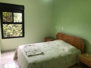 Een bed of bedden in een kamer bij Apartamento - Guarujá Marechi