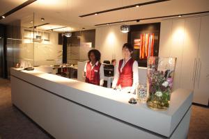 two women standing at a counter in a store at Hotel Schempp in Bobingen