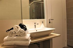 a bathroom with a sink and towels on a counter at Residence Pola in Catania +34 photos
