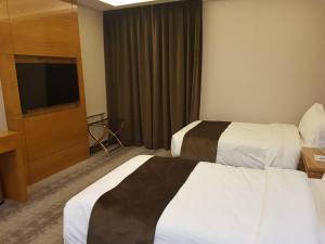 Postel nebo postele na pokoji v ubytování Gloria Hotel Amman