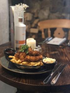 a plate of fried chicken and french fries on a table at The Strawbury Duck Inn in Darwen