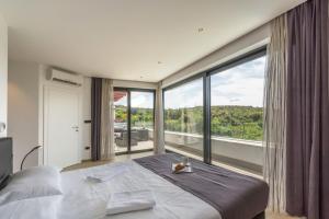 Postel nebo postele na pokoji v ubytování Villa Sara