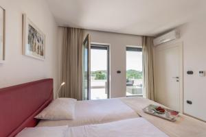 Postel nebo postele na pokoji v ubytování Villa Sara