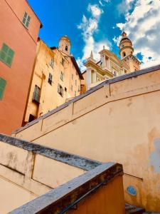 a view of a building from behind a wall at Les Sablettes in Menton