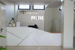 an office with a white reception desk in front of a wall at Kasa Imbondeiro in Mindelo