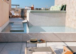 a swimming pool on top of a building at Hotel Antigua Palma - Casa Noble in Palma de Mallorca