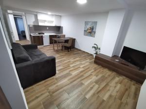 a living room with a couch and a table at SAPA Studios & Apartments in Niš