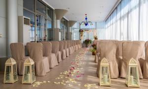 a row of chairs in a room with flowers on the floor at Hotel Attica21 Las Rozas in Las Rozas de Madrid