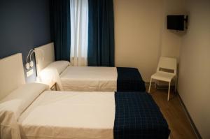 Postel nebo postele na pokoji v ubytování Hostal Mónaco
