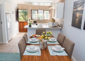a kitchen and dining room with a table and chairs at Brenton Breakers in Brenton-on-Sea