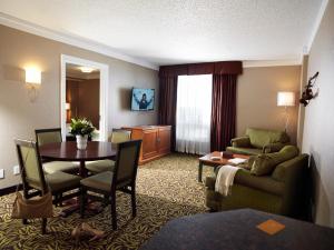 a hotel room with a table and a living room at Varscona Hotel on Whyte in Edmonton