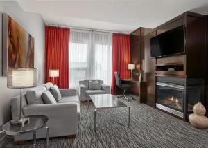a living room with a couch and a fireplace at Matrix Hotel in Edmonton