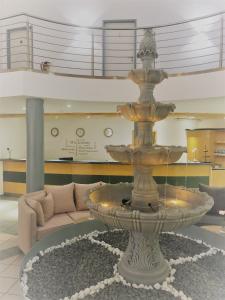 a fountain in the middle of a living room at A&M Hotel Barsinghausen in Bad Nenndorf