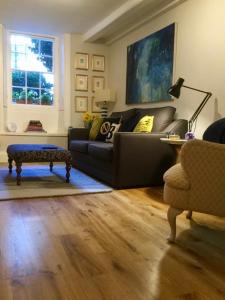 a living room with a couch and a table at Beautiful 1BR Apartment in Historic St Aubin House in Saint Aubin