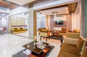 a living room with a couch and a table at Hotel La Villa Western by Sea Pearl Beach Resort & Spa in Dhaka