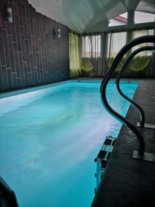 - une piscine d'eau bleue dans un bâtiment dans l'établissement Hôtel/Restaurant C'Vall, à Urepel