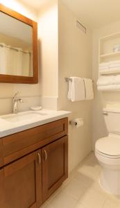 a bathroom with a sink and a toilet at Imperial Hawaii Resort in Honolulu