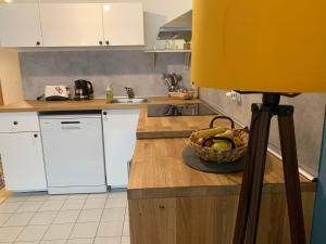 a kitchen with a bowl of fruit on a counter at Cosy apartment - Zagreb Downtown with own parking spot in the garage in Zagreb