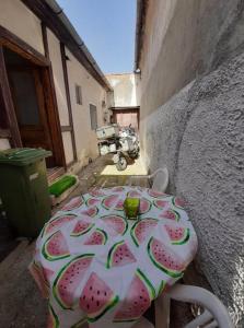 a table with slices of watermelon on it in an alley at Art Studio in Braşov