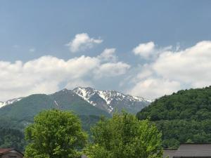 a view of a snow covered mountain with trees at Minh Ha Hotel in Lagi