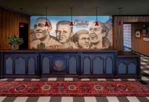 a large mural of three men on a wall at Graduate Columbus in Columbus