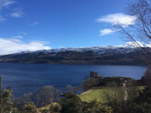 a castle on the shore of a large lake at Loch Ness Backpackers Lodge in Drumnadrochit