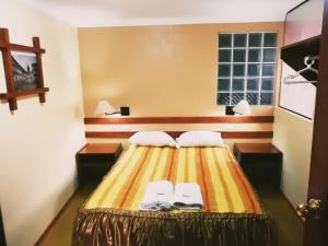 Postel nebo postele na pokoji v ubytování Conquista Cusco