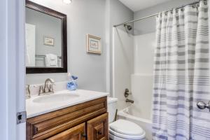a bathroom with a sink and a toilet and a shower at Tranquil Seas in Saint Joe Beach +26 photos