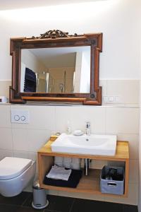 a bathroom with a sink and a mirror at Klimatisiertes Loft im Herzen von Deidesheim in Deidesheim +10 photos