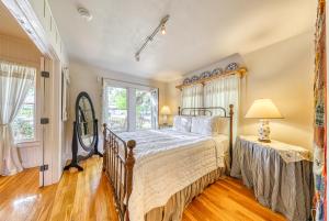 a bedroom with a bed and a window at Cosmos Cottage in Fredericksburg