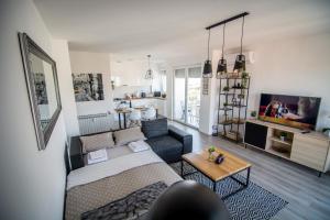 a living room with a couch and a tv at Sky in Slavonski Brod