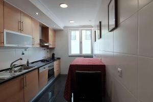 a kitchen with a table with a red table cloth on it at StayCozy in Lisbon