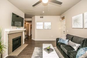 a living room with a couch and a fireplace at TPC Golf, Shopping & Dining 3 miles with Parking -1064 in Phoenix