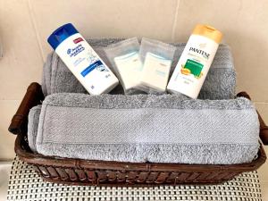 a basket with towels and products on a table at Estancia del Sol in Cabo San Lucas