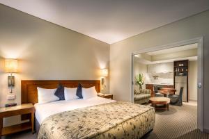 a hotel room with a bed and a living room at Batman's Hill on Collins in Melbourne +39 photos