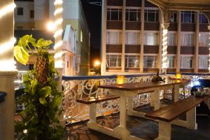 a table and benches on a balcony at night at Urban Hive Backpackers in Cape Town