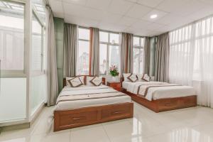 מיטה או מיטות בחדר ב-Diamond Luxury Ben Thanh