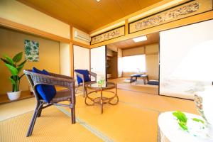 a living room with a table and chairs in a room at Awaji Seaside Resort in Shiduki1555 in Awaji +55 photos