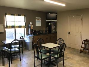 a dining room with a table and chairs and a kitchen at Super 8 by Wyndham Dillon in Dillon