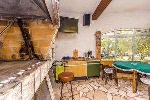 a kitchen with a table and a counter with a tableablish at Apartment Jasna summer barbeque in Srima